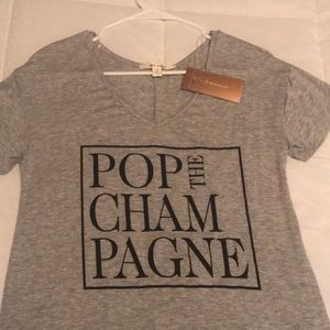 Pop the champagne loose fitting gray T-shirt.